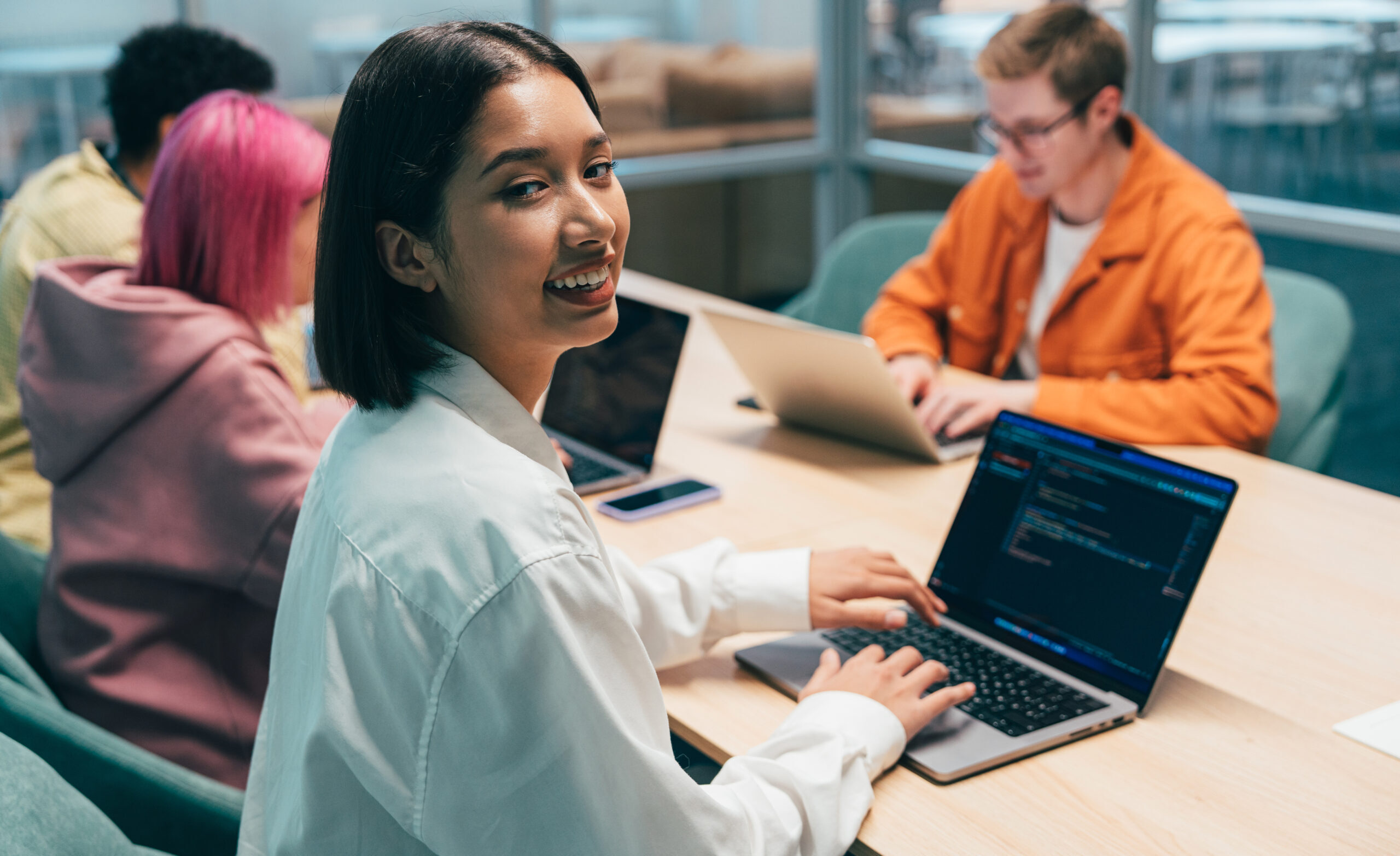 Cinematic image of a programming office with young programmers working on a new project for a start up business.